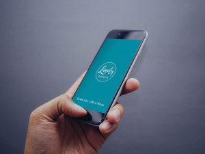 Free-iPhone-In-Hand-MockUp-on-Grey-Background